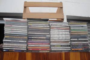 lot 107 image: About 70 CDs Mixed Artists and Styles of Music and 1 Small CD Rack