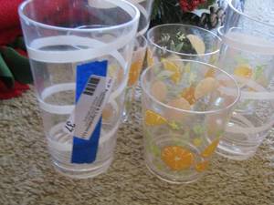 lot 37 image: 3 white strip plastic cups - 4 orange fruit design plastic cups