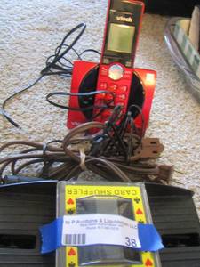 lot 38 image: automatic card shuffler, brown extension cord, red vtech home phone with base