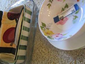 lot 39 image: plastic floral bowl, white dinner plate , plastic Santa platter, apple design casserole dish- floral casserole dish