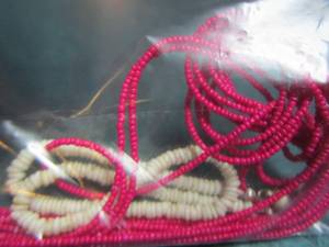 lot 21 image: Pink beaded necklace, White PUKA Necklace