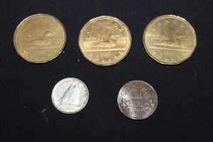 lot 86 image: Three 1987 Canadian Loonie Dollar Coins , 1951 canadian dime, and 1933 Canadian Penny