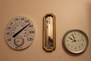 lot 193 image: Mirror, clock and Thermometer