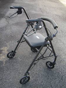 lot 26 image: walker on wheels and has seat