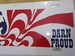 lot 213 image: LICENSE  plate covers saying DARN PROUD