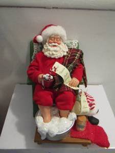 lot 426 image: Possible Dreams Santa sitting in his rocker sleep holding hot chocolate and holding the naughty list soaking his feet