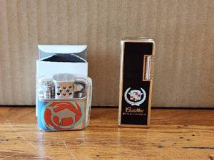 lot 43 image: Pair of collectible lighters - Camel and Cadillac