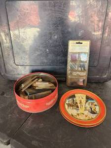 lot 172 image: Selection of dart accessories in collectible metal tin