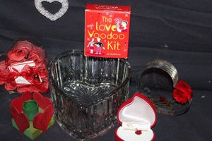 lot 12 image: Heart Themed Items, Crystal Heart Shaped Dish, faux Red Rose buds, Wooden Heart Candle Holder, Heart Shaped Red gift Box with Red Rose bud pendant on chain , Plastic Decorative Clear Heart, and Crystal Heart Shaped Ornament