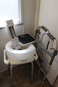 lot 31 image: Shower stool, Raised toilet Seat, shower grab bar scale and walker