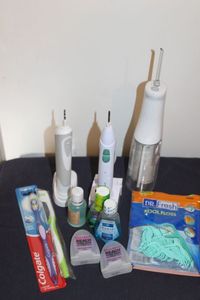 lot 32 image: Dental Care Items, water Pick and electric toothbrushes, Floss and more