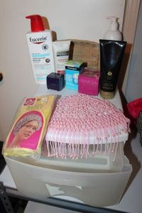 lot 54 image: Skin Care items and shower cap and beaded cap