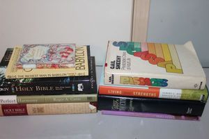 lot 75 image: Books Passages Predicatable Crises of Adult Life, Living your Strengths, Emily Posts Ediquite, NIV Holy Bible Wide Margain Edition, A Perfect Harmony, NKJV Bible and the Richest Man in Bablon