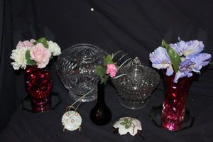 lot 180 image: Glassware Anchor Hocking Footed, Wexford Heavy Crysal Candy Dish with Lid, Lead Crystal Starburst Pineapple Footed Rose Bowl, 2 Pink Footed Glass Vases, Ceramic Black Bud Vase, All Flowers Pictured