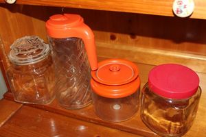 lot 258 image: Vintage Glass 2 Quart Beverage Pitcher Clear Glass with Orange Lid, Three Glass Canister Jars with lids