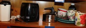 lot 264 image: Coffee Bean Grinder, Black and Decker Black Toaster, Stainless Steele Tea Kettle, Pioneer Woman Plates and Tea Cups, Loose Leaf Tea holder and Honey unopened