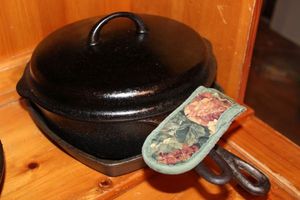 lot 266 image: Two Cast Iron Pans 1 Square Frying pan by Jones Dairy Farm, 1 Large Dutch Oven with Lid and Handle Mitten