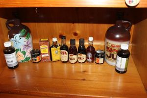 lot 316 image: Maple Syrups, Cola Flavoring and collectable bottle Apple Wine Must be 21 to purchase