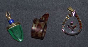 lot 326 image: Green Gobi Agate Arrow, and Handmade Teardrop Glass with Rose etched Pendants, also Coke on Ice Finger Pick