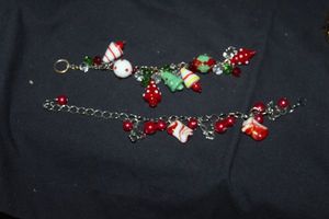 lot 373 image: Two Silver Charm Bracelets, one with Glass Christmas Tree  and ornament Shaped Charms, The other with Beads, Butterflies and Glass Candy looking Charms