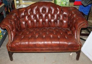 lot 27 image: Brown Leather Loveseat 58x30x34