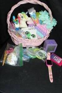 lot 133 image: Easter Themed Items, and Unicorn Cake Decorations, Plastic Bracelets, Alarm Clock and smart Watch