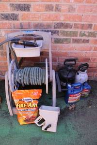 lot 9 image: Garden hose reel with flex hose, fire ant and weed killers and spreaders