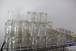 lot 12 image: Kerr and Ball canning jars plus reusable glass jars