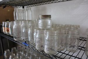 lot 13 image: Kerr, Ball, and Presto canning jars plus reusable glass jars