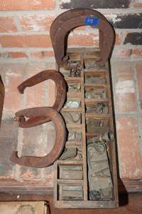 lot 61 image: Vintage horseshoes and cast iron letternumber blocks typesetting