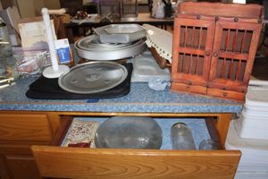 lot 91 image: Misc. household items clear plates, nesting cake pans, marble style paper towel holder and more