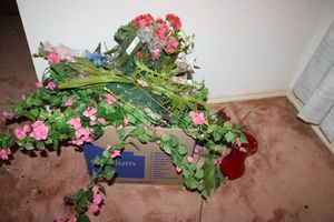 lot 122 image: Artificial flowers with red glass vase