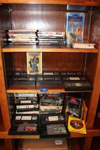 lot 135 image: VHS and DVD movies with vintage Nintendo games