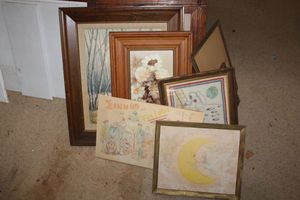 lot 212 image: Vintage wall art with cartoon drawing and cross-stitch moon landing