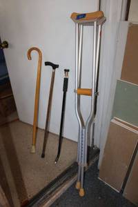 lot 215 image: Crutches, walking canes and hose extender