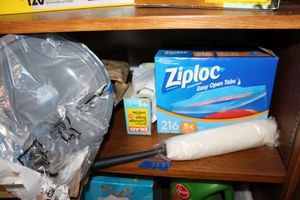 lot 282 image: Ziploc freezer bags, duster, garbage bags, replacement stove pans, and steel wool