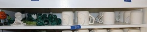 lot 344 image: Unfinished ceramic bisque mugs and finished napkin rings