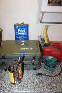 lot 439 image: Metal spikes, palm sander, paint thinner, gas can, storage bins