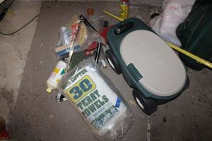 lot 534 image: Terry towels, plastic garden cart stool , and tools