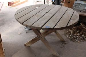 lot 573 image: Wood round patio table with umbrella hole