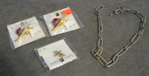 lot 86 image: hat shirt pins, child shirt pin, chain bracelet