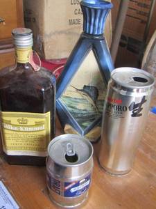 lot 104 image: JIM BEAM SAILFISH  DECANTOR, empty beer cans and  empty glass bottle