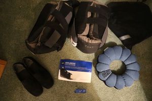 lot 15 image: Heel Medix heel protectors, total pillow, and womens black shoes (maybe size 6)
