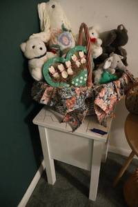 lot 21 image: Basket of plush toys with crackle top side table
