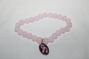 lot 172 image: Jewelry Pink gemstone bracelet with pink ribbon charm (sterling silver)