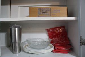 lot 49 image: Corning ware plates, travel mug, microwave potato cookers, and glass communion cups