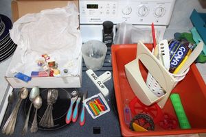 lot 43 image: Misc. kitchen lot frig magnets, silver plate flatware, Gerber kids set, salt and pepper grinders and more