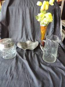 lot 119 image: Wavy Decorative Plate a Glass Pitcher with a K on it Jar with lid Orande Colered vase with Artifical flowers
