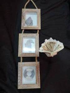 lot 212 image: ocean themed wall hanger and a decorative shell