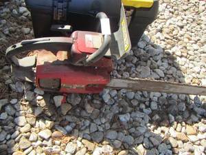 lot 130 image: black and yellow tool box- chain saw